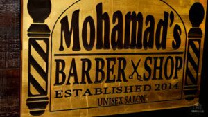 A vintage looking sign of a barber shop called Mohamad's Barbershop